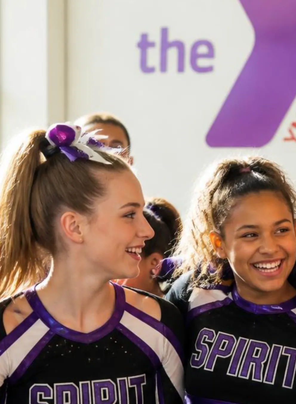group of cheerleaders laughing