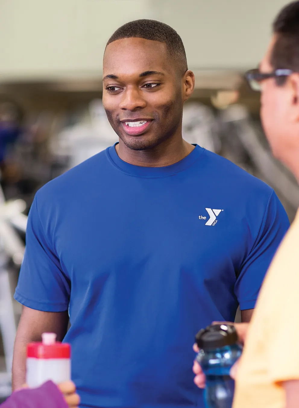 personal trainer talking to member