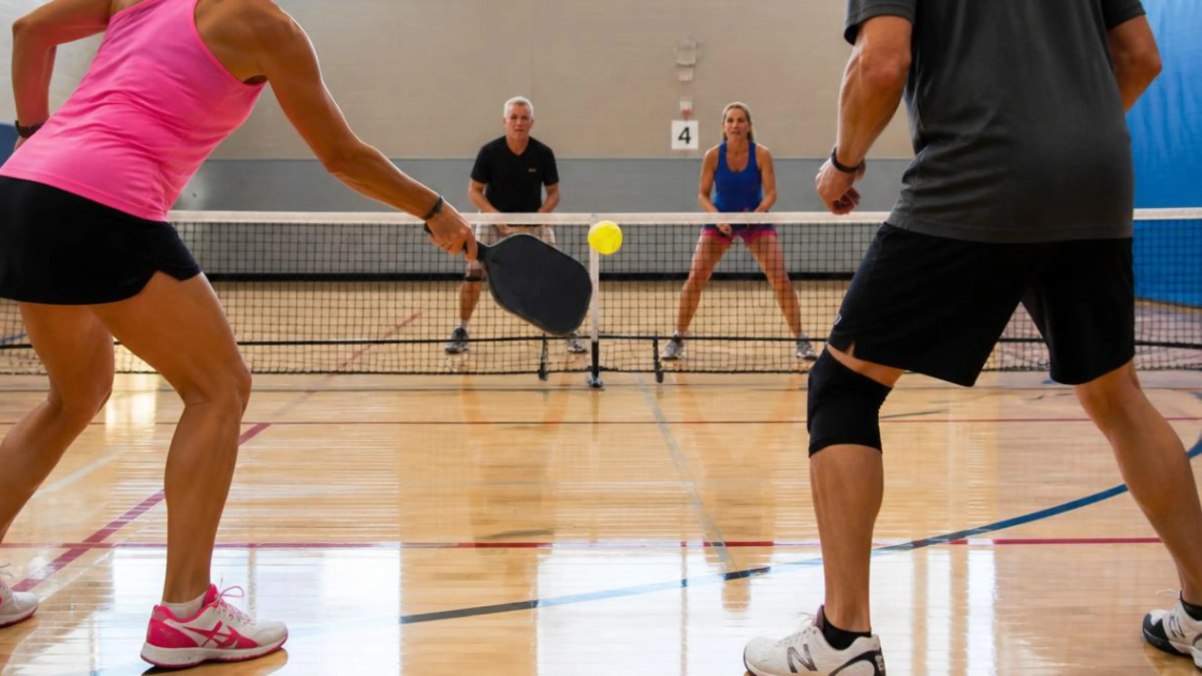 4 players playing pickleball