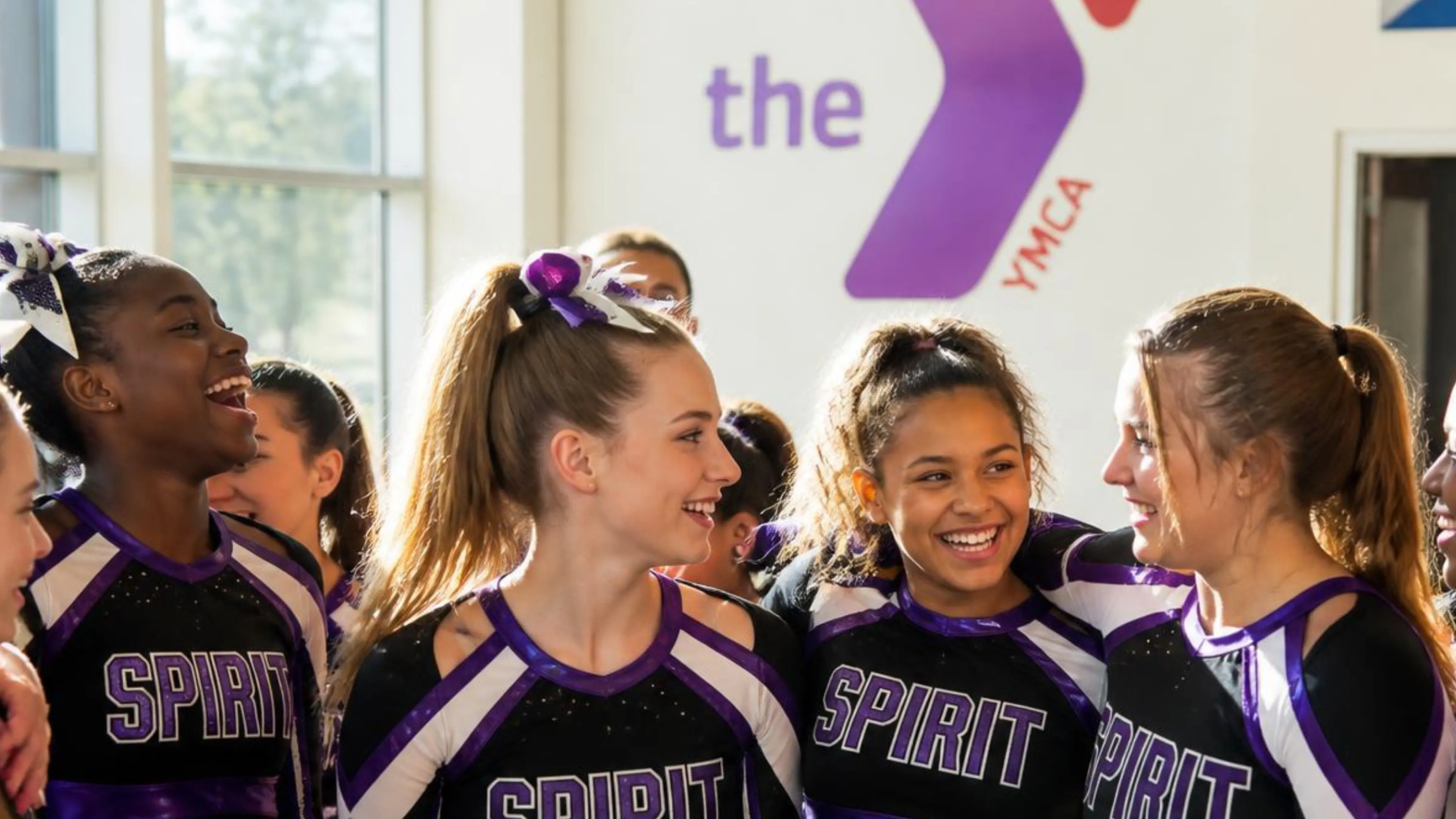 group of cheerleaders laughing