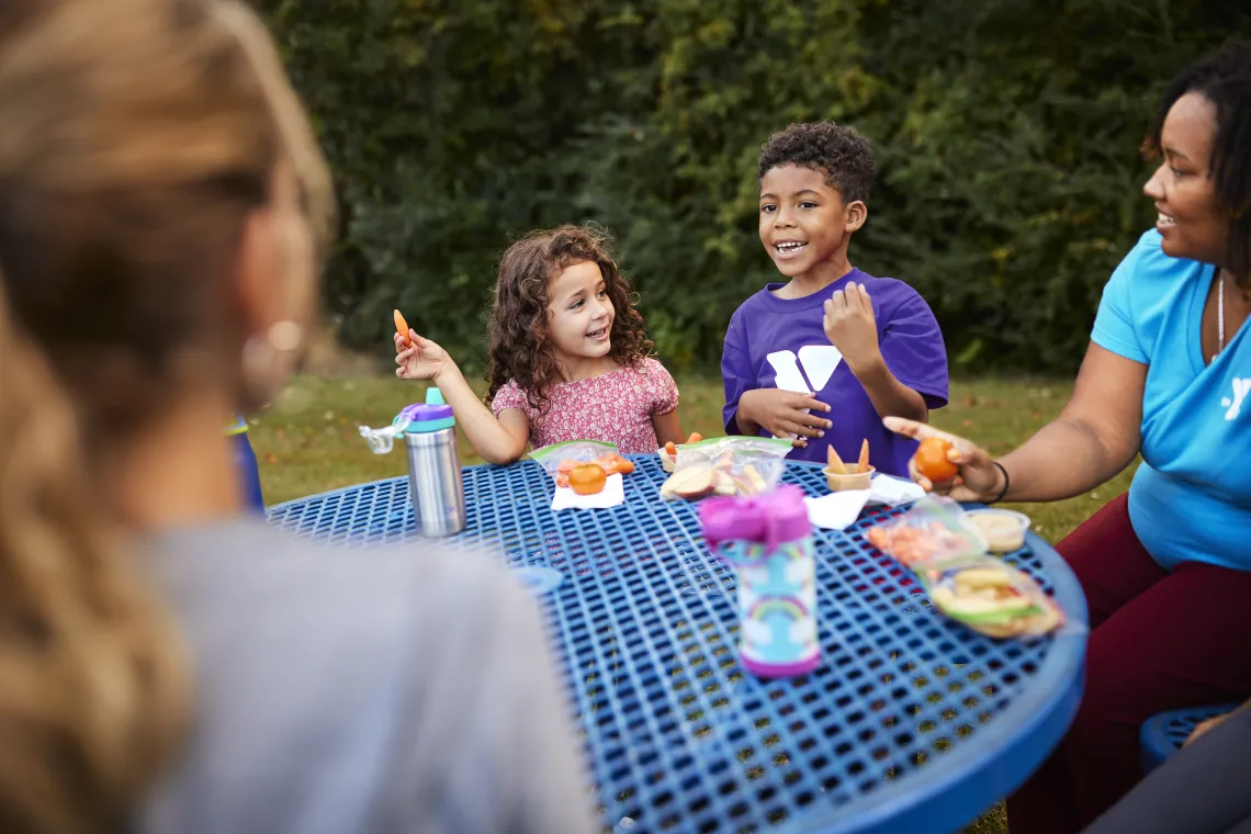 Children enjoying lunch at day camp.