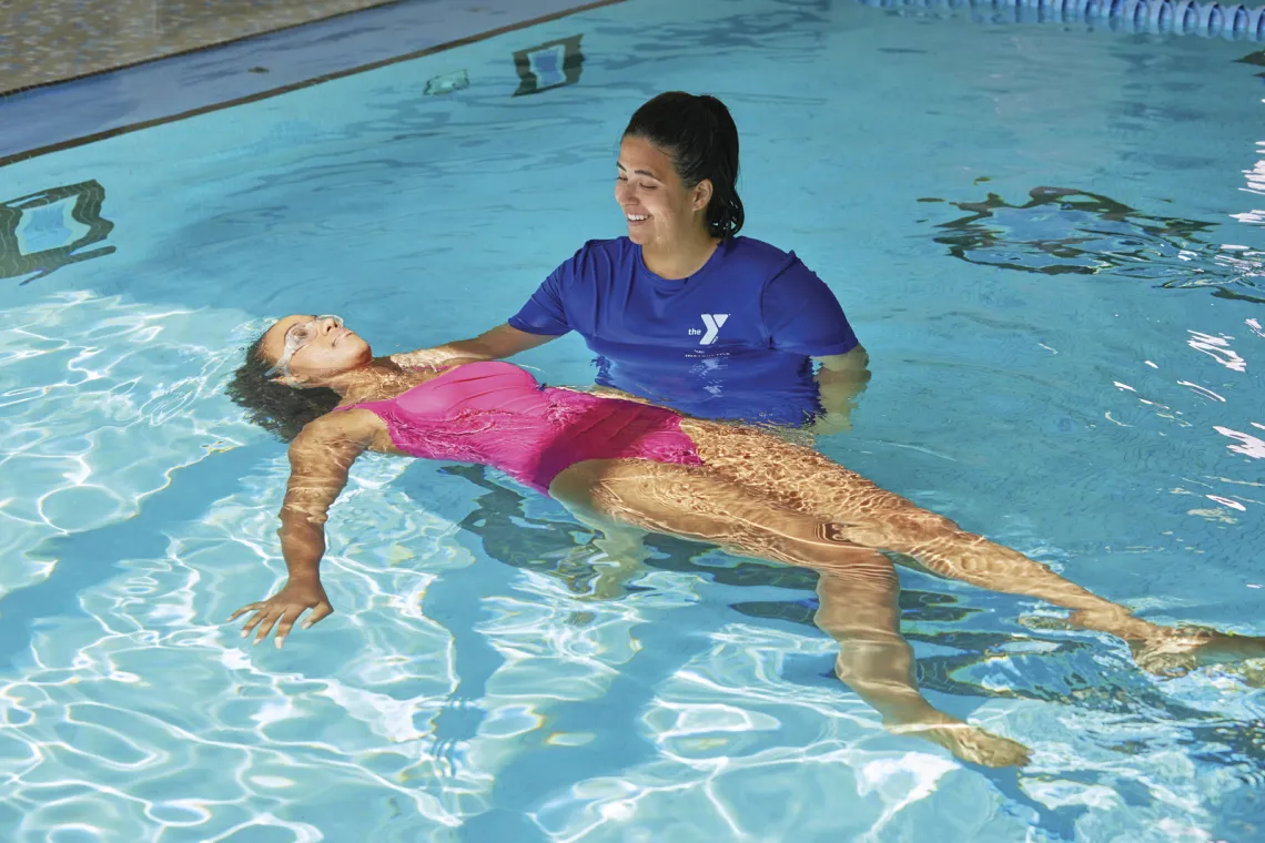 instructor helping swimmer