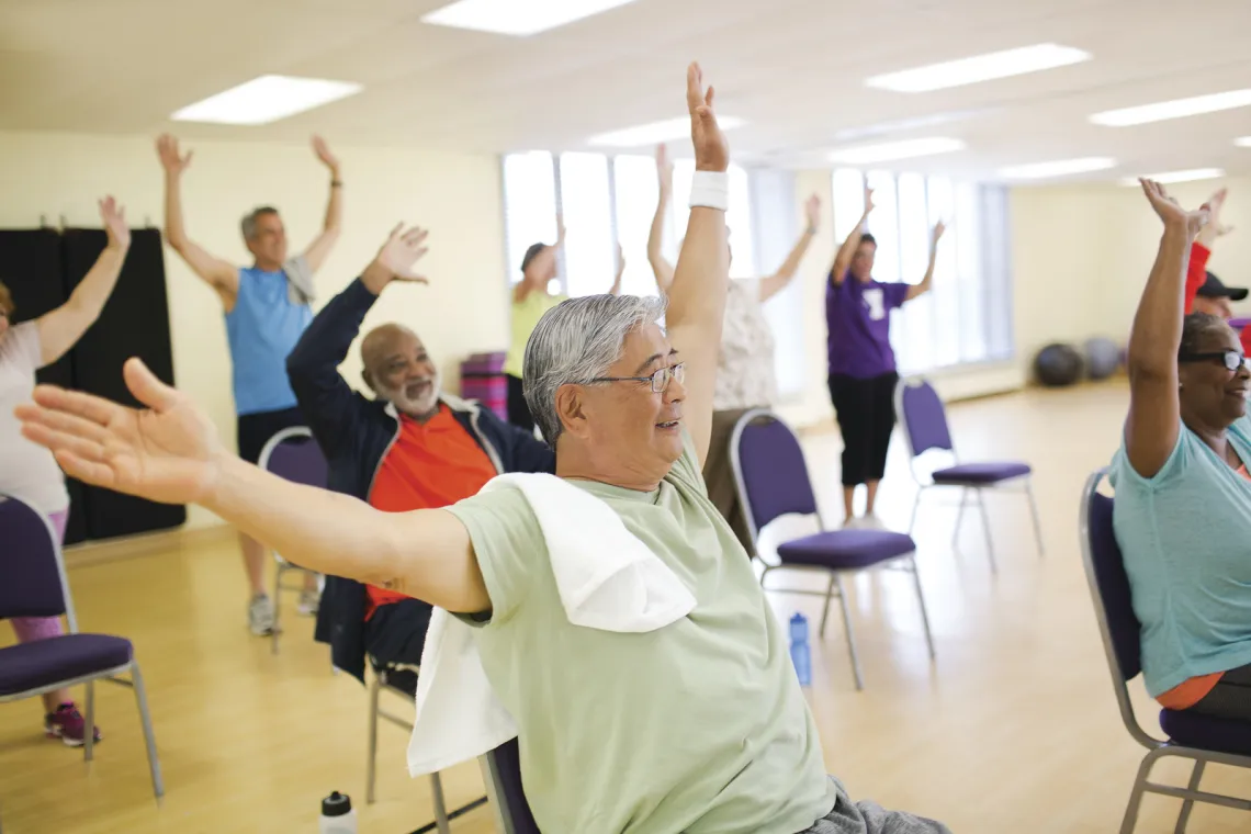 seniors in stretch class on chairs